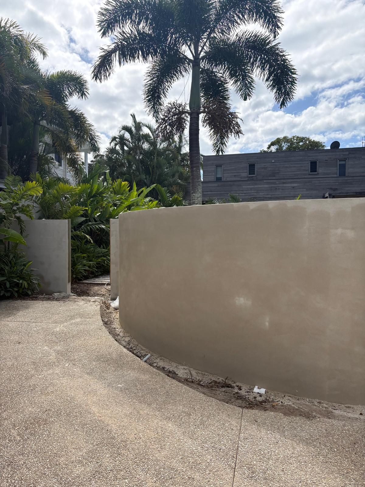 Curved rendered wall and timber detail on an Oceanside project
