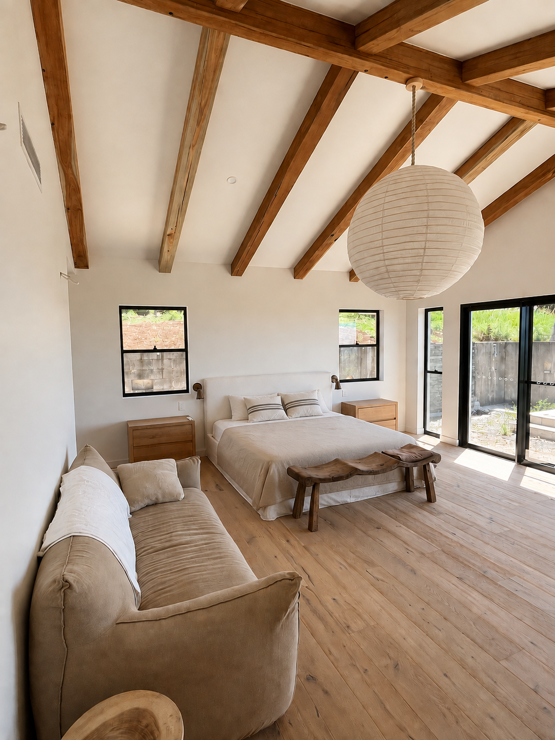 Primary bedroom with vaulted ceilings and ocean views at Newrybar